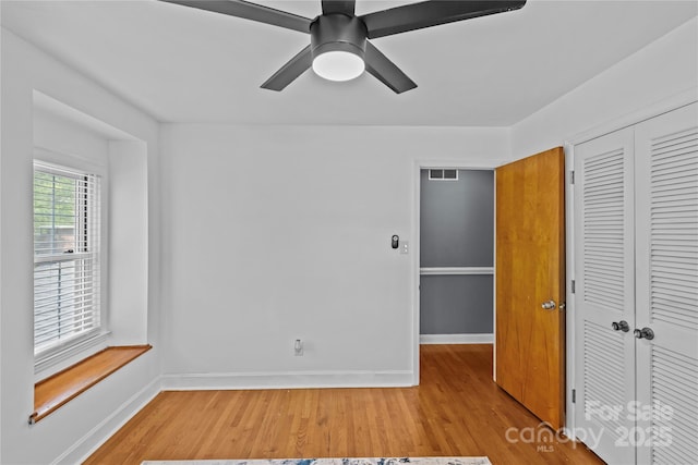 6035 Idlebrook Dr, Charlotte, NC 28212 - unfurnished bedroom with a closet, light wood finished floors, and ceiling fan