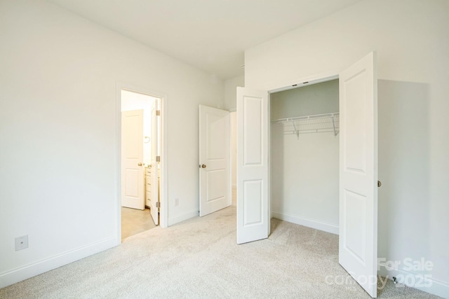 81 Walnut Springs Dr Unit 22-D, Asheville, NC 28804 - unfurnished bedroom with light carpet, a closet, baseboards, and connected bathroom