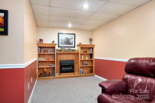 15 Heather Ln, Fairview, NC 28730 - living area featuring carpet floors, a paneled ceiling, a glass covered fireplace, and baseboards