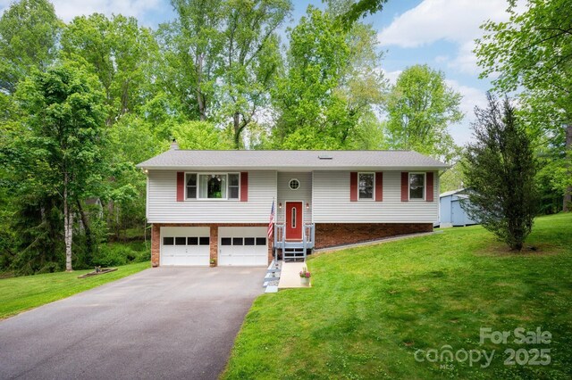 15 Heather Ln, Fairview, NC 28730 - split foyer home with driveway, an attached garage, a front yard, and a chimney