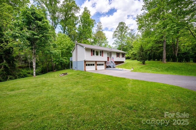15 Heather Ln, Fairview, NC 28730 - split foyer home featuring an attached garage, asphalt driveway, and a front yard