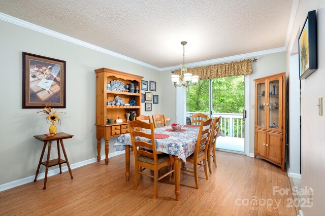 15 Heather Ln, Fairview, NC 28730 - dining room with a chandelier, light wood finished floors, a textured ceiling, crown molding, and baseboards