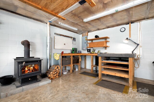 15 Heather Ln, Fairview, NC 28730 - below grade area with a wood stove, concrete block wall, and electric panel