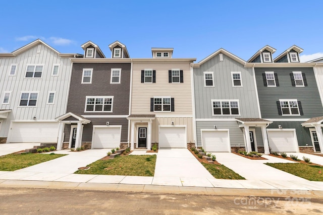 184 Cherry Springs Ln Unit 1-B, Asheville, NC 28804 - townhome / multi-family property featuring board and batten siding, an attached garage, driveway, and stone siding