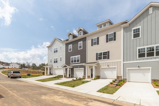 184 Cherry Springs Ln Unit 1-B, Asheville, NC 28804 - townhome / multi-family property featuring an attached garage, board and batten siding, and driveway