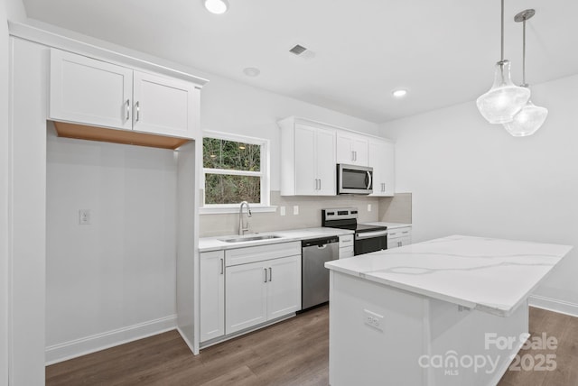 184 Cherry Springs Ln Unit 1-B, Asheville, NC 28804 - kitchen with a sink, appliances with stainless steel finishes, a kitchen island, and dark wood-style flooring