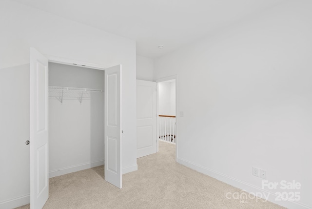184 Cherry Springs Ln Unit 1-B, Asheville, NC 28804 - unfurnished bedroom featuring baseboards, light colored carpet, and a closet