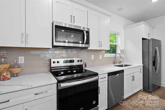 184 Cherry Springs Ln Unit 1-B, Asheville, NC 28804 - kitchen featuring stainless steel appliances, wood finished floors, white cabinetry, and light stone countertops