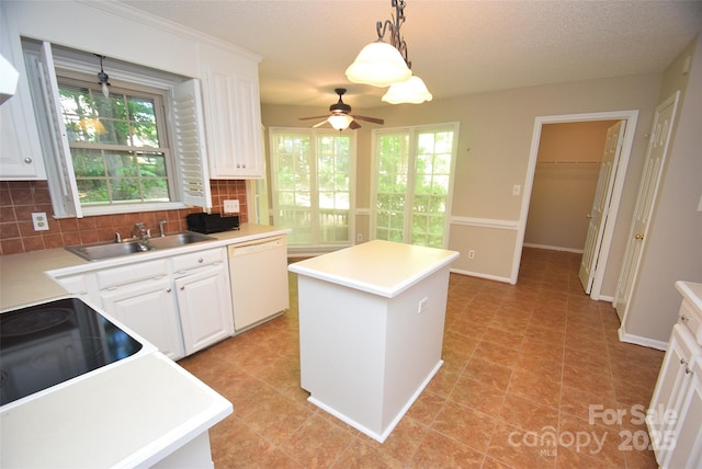 4704 Beech Crest Pl, Charlotte, NC 28269 - kitchen featuring a kitchen island, white dishwasher, a sink, backsplash, and decorative light fixtures