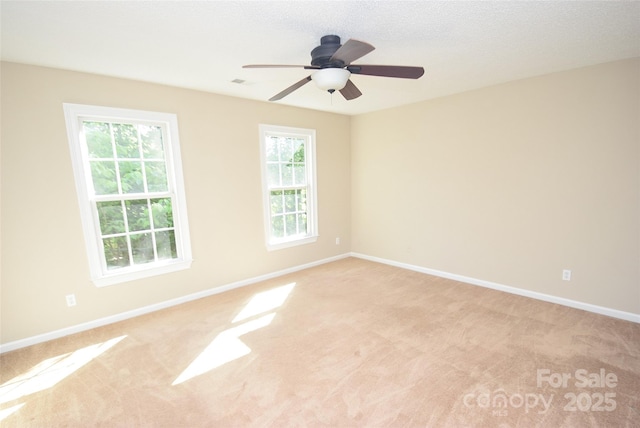 4704 Beech Crest Pl, Charlotte, NC 28269 - spare room with baseboards, ceiling fan, a wealth of natural light, and light carpet