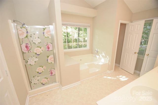 4704 Beech Crest Pl, Charlotte, NC 28269 - bathroom with a garden tub, baseboards, lofted ceiling, and a stall shower