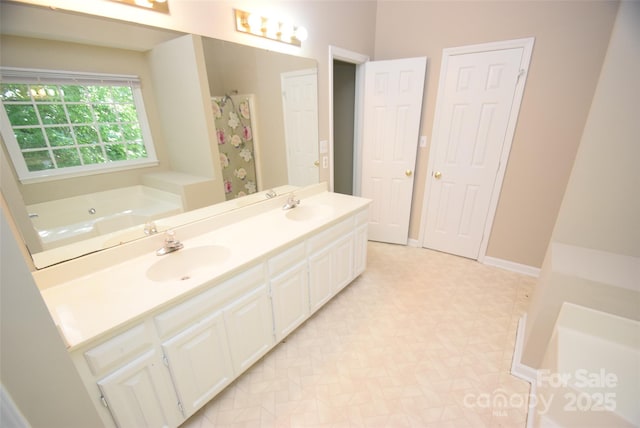4704 Beech Crest Pl, Charlotte, NC 28269 - bathroom featuring a garden tub, a sink, baseboards, and double vanity