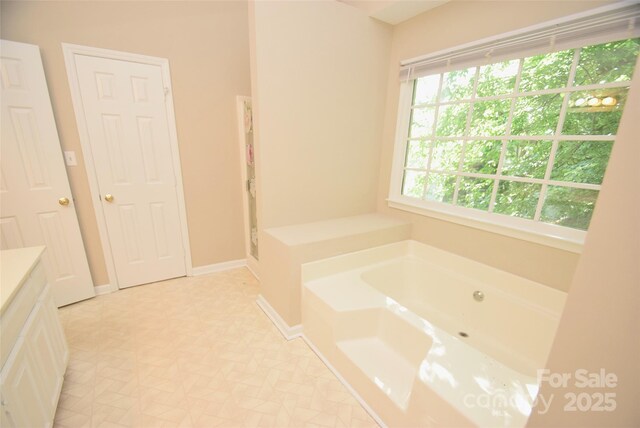 4704 Beech Crest Pl, Charlotte, NC 28269 - bathroom with vanity, baseboards, and a bath