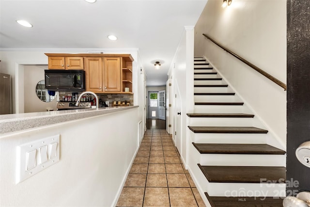 4605 Hedgemore Dr Unit I, Charlotte, NC 28209 - kitchen with recessed lighting, black microwave, open shelves, and light tile patterned floors