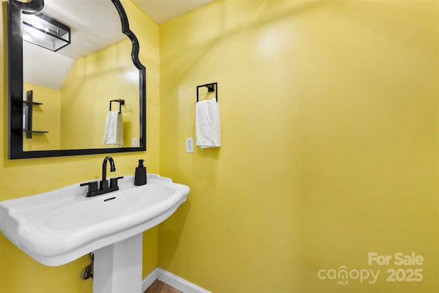 4605 Hedgemore Dr Unit I, Charlotte, NC 28209 - bathroom with baseboards and a sink