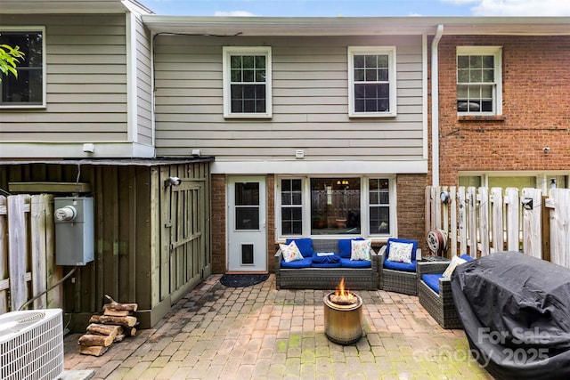 4605 Hedgemore Dr Unit I, Charlotte, NC 28209 - back of property with brick siding, an outdoor living space with a fire pit, central AC, and a patio