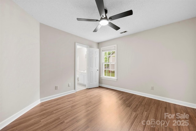 13324 Kintyre Ct, Matthews, NC 28105 - spare room with a textured ceiling, wood finished floors, baseboards, and ceiling fan