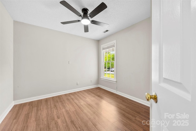 13324 Kintyre Ct, Matthews, NC 28105 - unfurnished room featuring wood finished floors, baseboards, ceiling fan, and a textured ceiling
