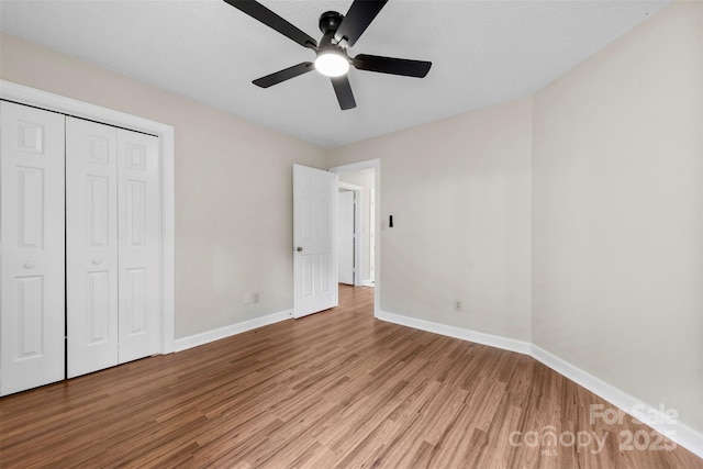 13324 Kintyre Ct, Matthews, NC 28105 - unfurnished bedroom featuring light wood finished floors, baseboards, a closet, and a ceiling fan