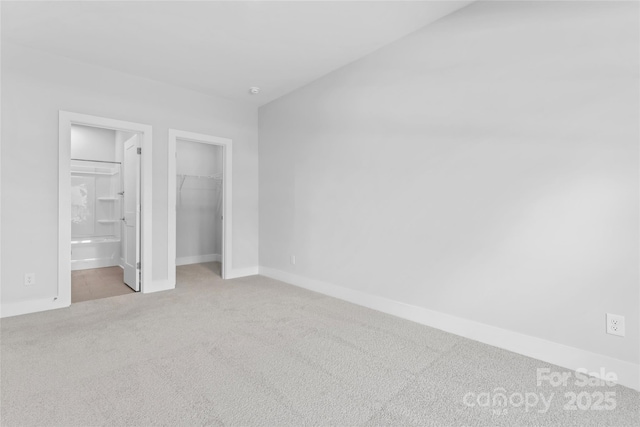 714 Falling Oak Aly Unit 18, Huntersville, NC 28078 - unfurnished bedroom with ensuite bathroom, baseboards, a spacious closet, a closet, and carpet floors