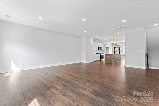 714 Falling Oak Aly Unit 18, Huntersville, NC 28078 - unfurnished living room featuring baseboards, dark wood-style flooring, and recessed lighting