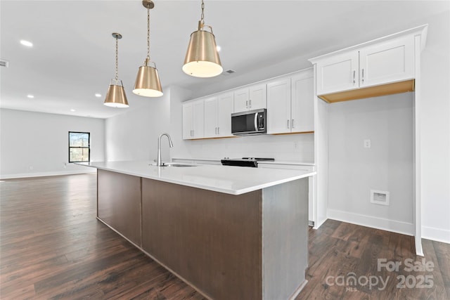 714 Falling Oak Aly Unit 18, Huntersville, NC 28078 - kitchen with white cabinets, dark wood finished floors, a sink, stainless steel microwave, and baseboards