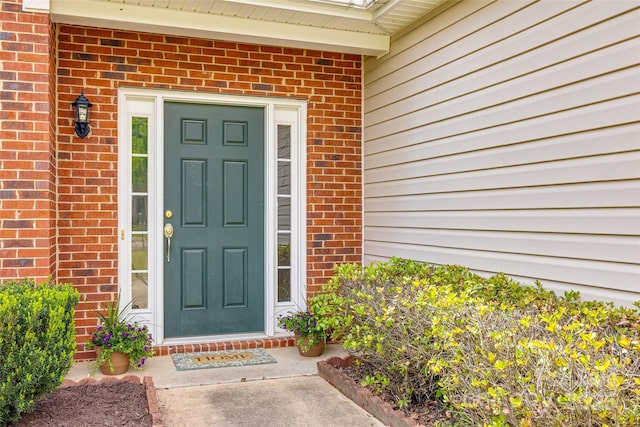 entrance to property with brick siding