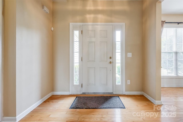 entryway featuring light wood finished floors and baseboards