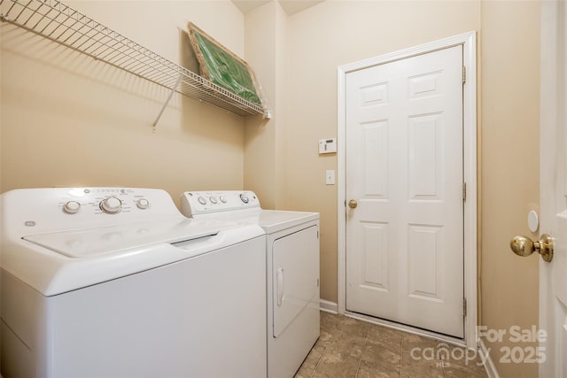 laundry room featuring separate washer and dryer, laundry area, and baseboards