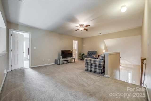 living area featuring ceiling fan, carpet, and baseboards