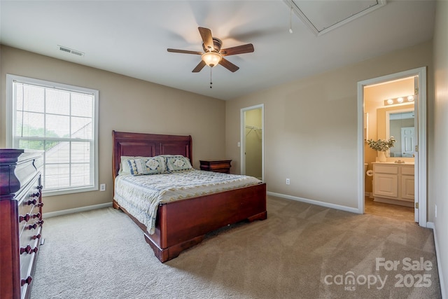 bedroom featuring a spacious closet, visible vents, attic access, carpet flooring, and baseboards