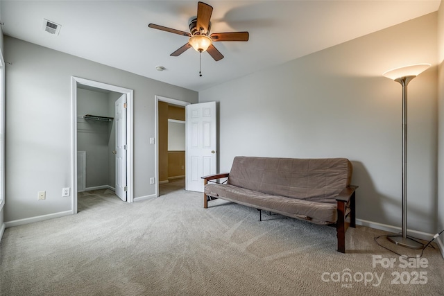 living area with carpet, visible vents, baseboards, and ceiling fan
