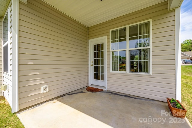 view of exterior entry featuring a patio