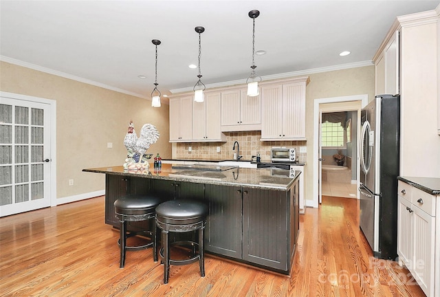 729 Lochaven Rd, Waxhaw, NC 28173 - kitchen with freestanding refrigerator, a sink, light wood-style flooring, a kitchen island, and tasteful backsplash