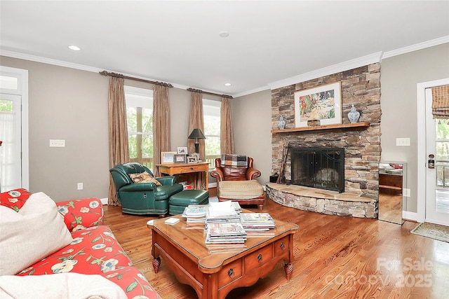 729 Lochaven Rd, Waxhaw, NC 28173 - living area with wood finished floors, ornamental molding, a stone fireplace, baseboards, and recessed lighting