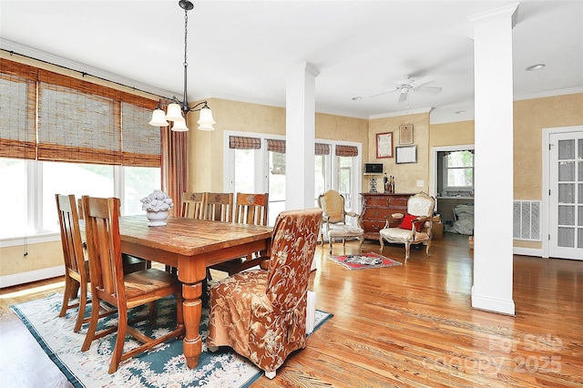 729 Lochaven Rd, Waxhaw, NC 28173 - dining area featuring light wood-style flooring, decorative columns, ornamental molding, ceiling fan, and a chandelier