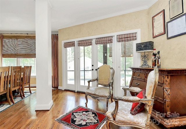 729 Lochaven Rd, Waxhaw, NC 28173 - living area with healthy amount of natural light, wood finished floors, ornamental molding, ornate columns, and french doors