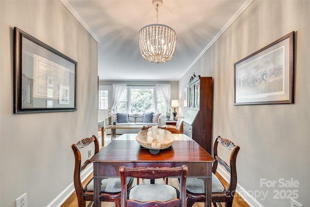 4607 Hedgemore Dr Unit H, Charlotte, NC 28209 - dining room featuring baseboards, a chandelier, and ornamental molding