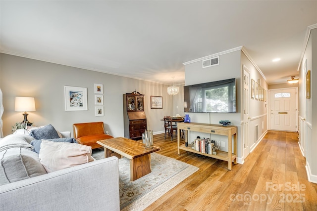 4607 Hedgemore Dr Unit H, Charlotte, NC 28209 - living area with crown molding, visible vents, and light wood finished floors