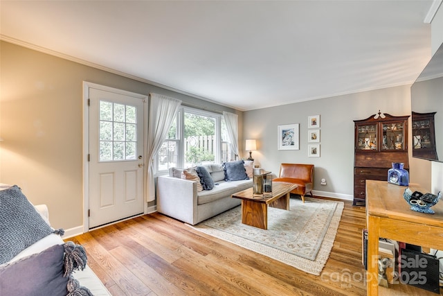 4607 Hedgemore Dr Unit H, Charlotte, NC 28209 - living area featuring light wood-style flooring, baseboards, and crown molding