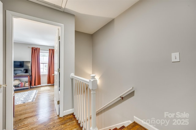 4607 Hedgemore Dr Unit H, Charlotte, NC 28209 - hall featuring wood finished floors, baseboards, and an upstairs landing