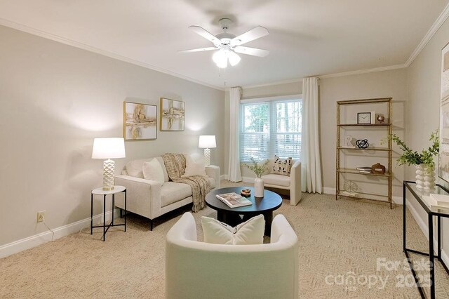 living area featuring carpet flooring, crown molding, baseboards, and ceiling fan