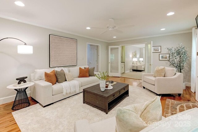 living room with baseboards, recessed lighting, wood finished floors, ceiling fan, and ornamental molding