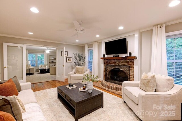 living room with recessed lighting, crown molding, a healthy amount of sunlight, and a ceiling fan