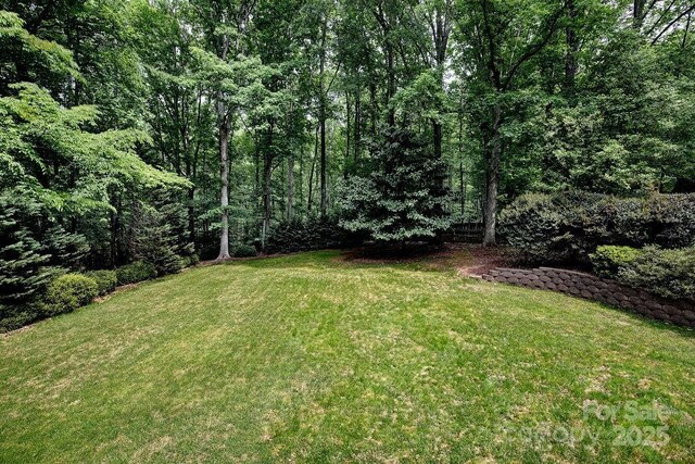 view of yard with a wooded view