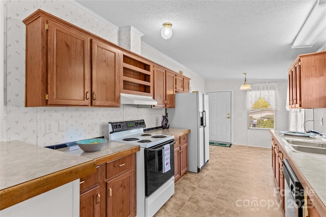 kitchen featuring a sink, wallpapered walls, white appliances, light countertops, and under cabinet range hood