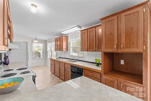 kitchen with light countertops, brown cabinetry, a sink, and white appliances