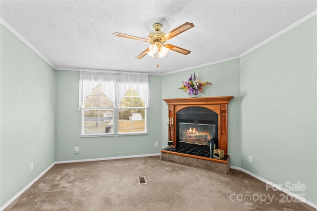 unfurnished living room with crown molding, a fireplace, a textured ceiling, carpet flooring, and ceiling fan