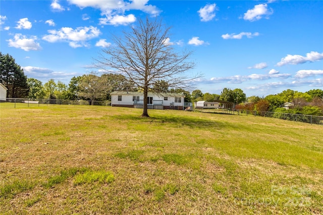 view of yard with fence and a carport