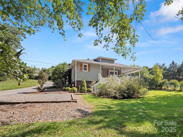 back of house with a lawn and stairs